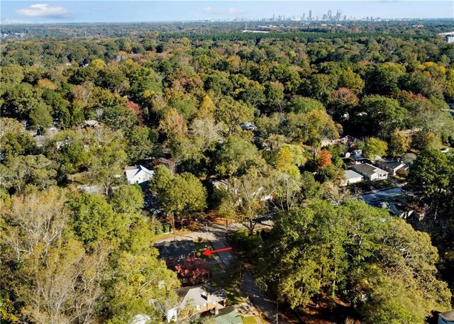 birds eye view of property featuring a view of trees