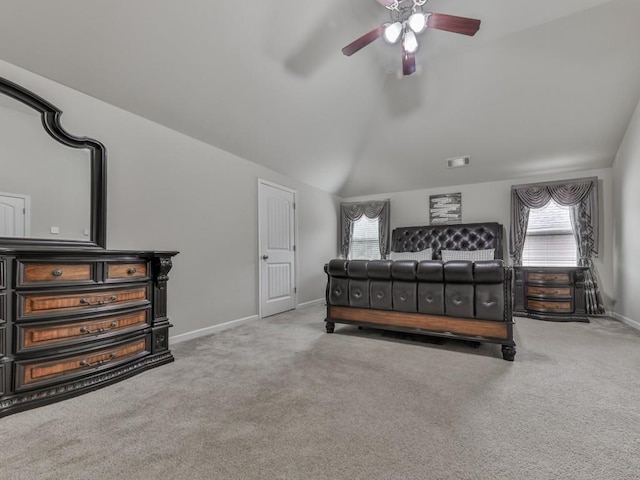 bedroom featuring multiple windows, carpet flooring, vaulted ceiling, and ceiling fan