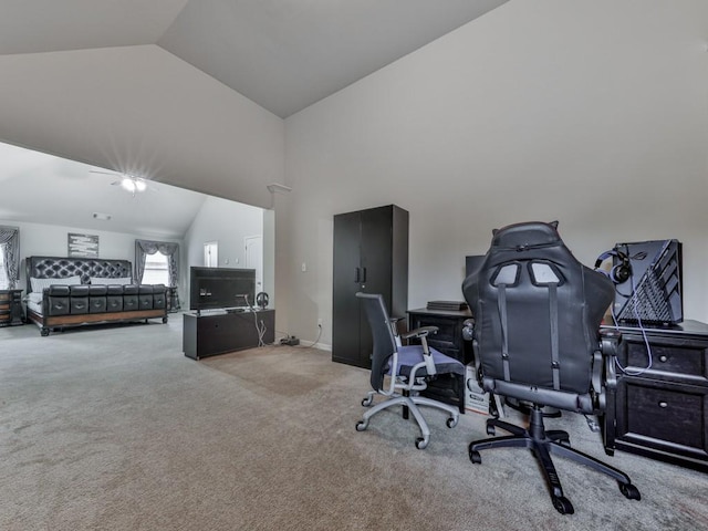 carpeted home office featuring vaulted ceiling