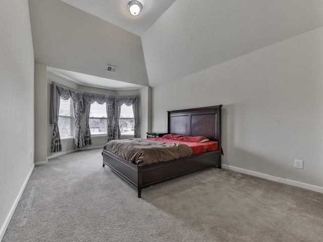 carpeted bedroom featuring high vaulted ceiling