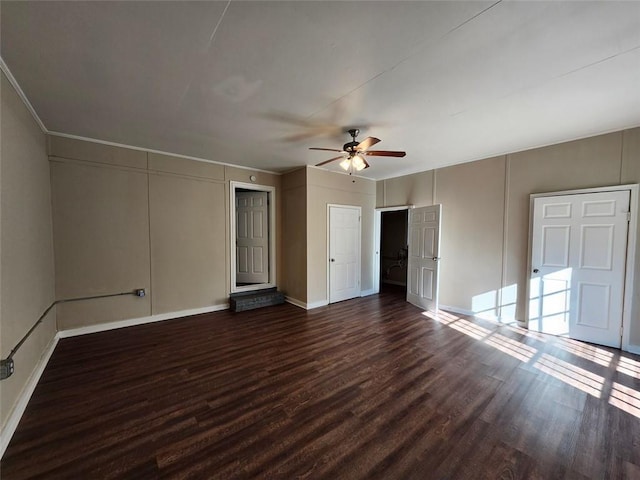 interior space with ceiling fan and dark hardwood / wood-style floors