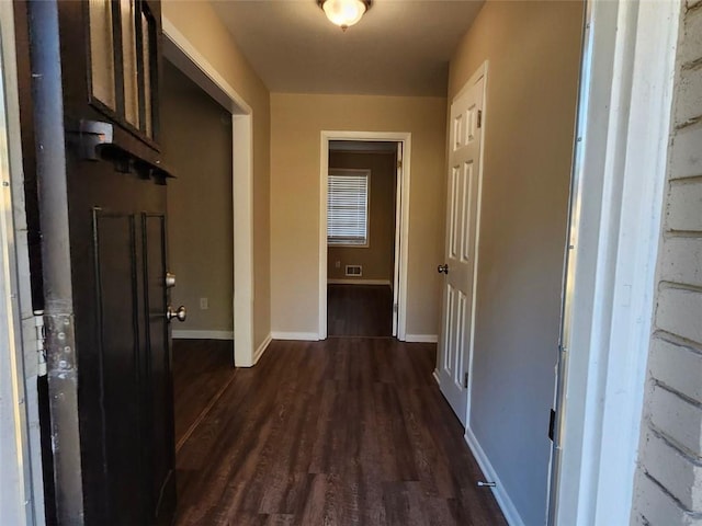 hallway with dark hardwood / wood-style floors