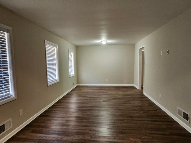 empty room featuring dark wood-type flooring