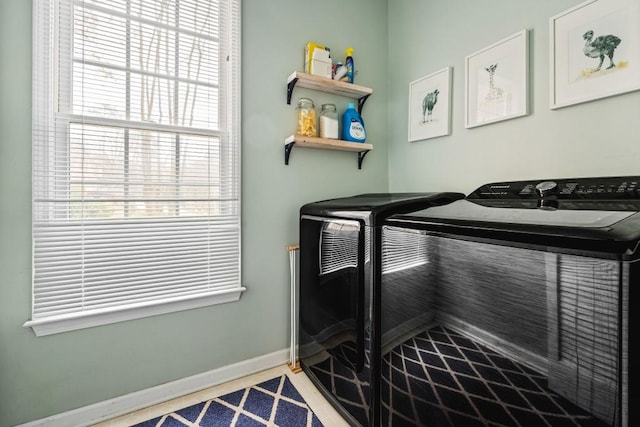 miscellaneous room featuring baseboards and independent washer and dryer