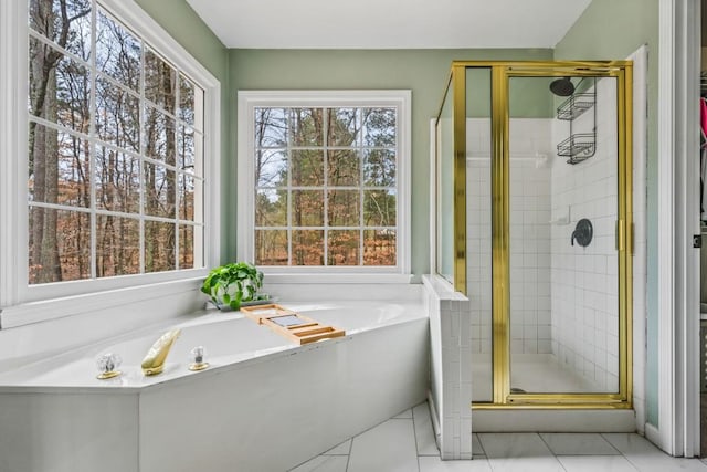 full bathroom featuring a stall shower, tile patterned flooring, and a garden tub