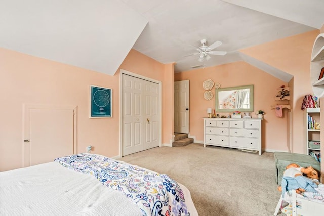 bedroom with baseboards, a ceiling fan, lofted ceiling, carpet floors, and a closet