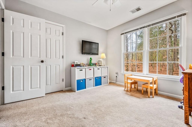 recreation room with visible vents, baseboards, ceiling fan, and carpet flooring