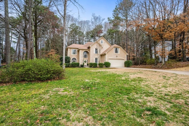 view of front of property featuring a front yard, driveway, and stucco siding