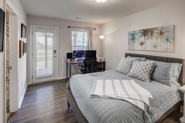 bedroom with access to outside and dark hardwood / wood-style floors