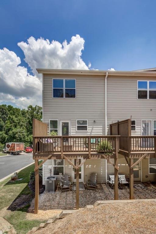 rear view of house featuring central AC and a deck