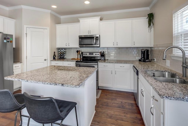 kitchen featuring tasteful backsplash, stainless steel appliances, dark hardwood / wood-style flooring, crown molding, and sink