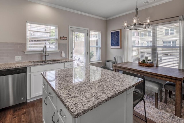 kitchen featuring dark hardwood / wood-style flooring, decorative backsplash, sink, dishwasher, and a center island