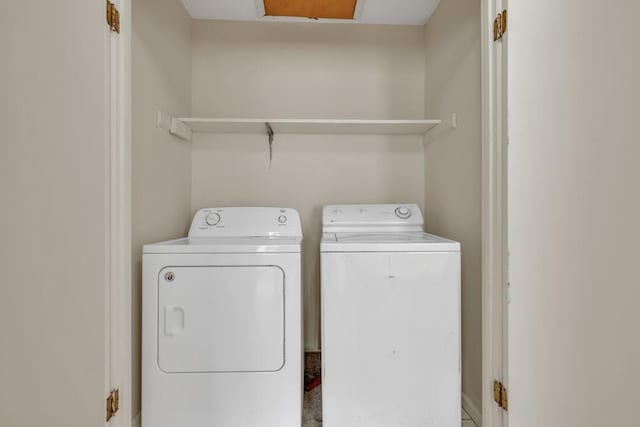 clothes washing area with separate washer and dryer and laundry area