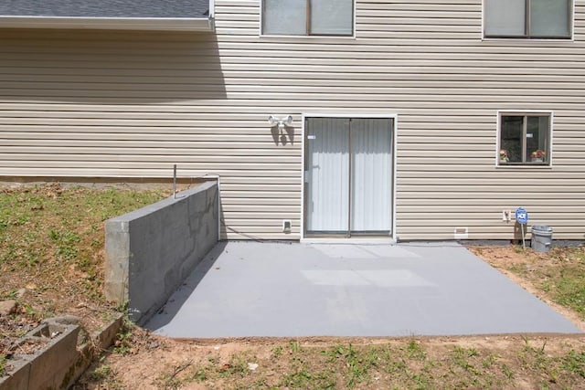 view of exterior entry featuring a patio