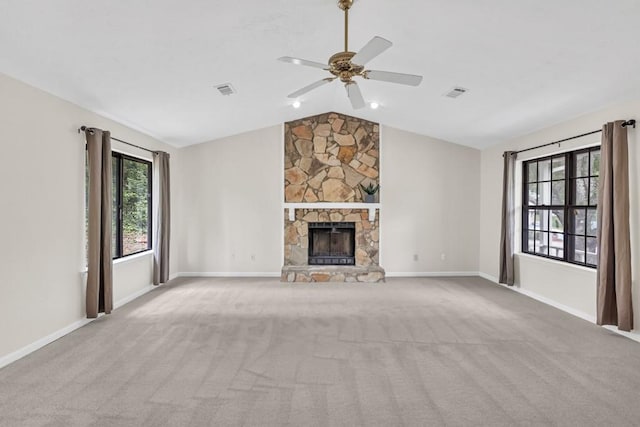 unfurnished living room with ceiling fan, visible vents, vaulted ceiling, carpet floors, and baseboards