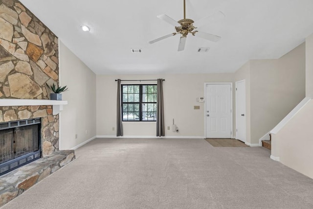 unfurnished living room with carpet floors, a ceiling fan, visible vents, and a fireplace