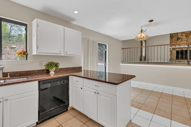 kitchen featuring plenty of natural light, a sink, a peninsula, and black dishwasher