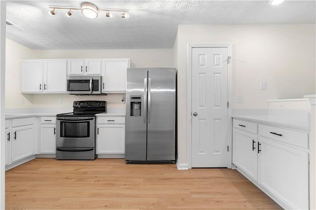 kitchen featuring white cabinets, light countertops, and stainless steel appliances