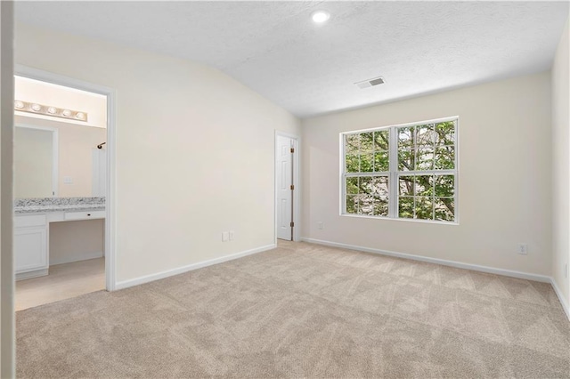 unfurnished bedroom featuring baseboards, visible vents, and light colored carpet