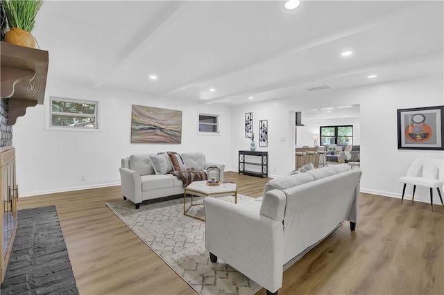 living room with light wood-type flooring and a fireplace