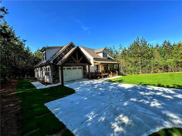 136 Rainey Rd, Temple, GA 30179 - view of front of house featuring stone siding, driveway, covered porch, a front lawn, and a garage