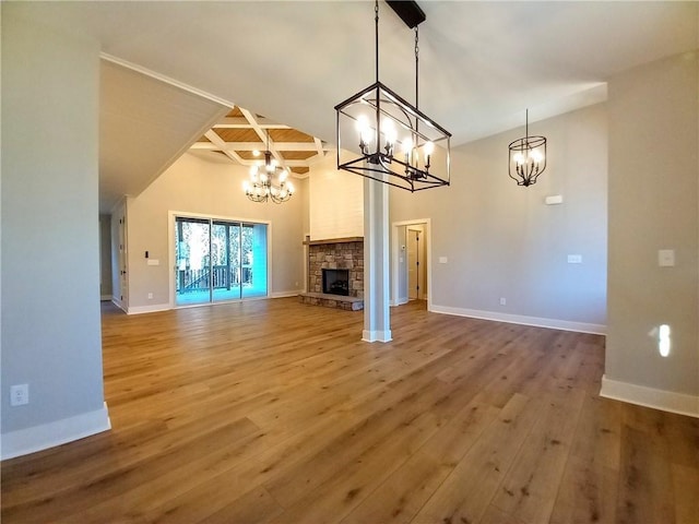 136 Rainey Rd, Temple, GA 30179 - unfurnished living room featuring a chandelier, wood finished floors, a fireplace, beam ceiling, and coffered ceiling