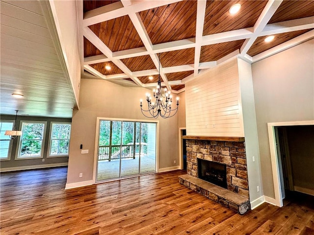 136 Rainey Rd, Temple, GA 30179 - unfurnished living room featuring coffered ceiling, a chandelier, hardwood / wood-style floors, a fireplace, and a wooden ceiling with exposed beams
