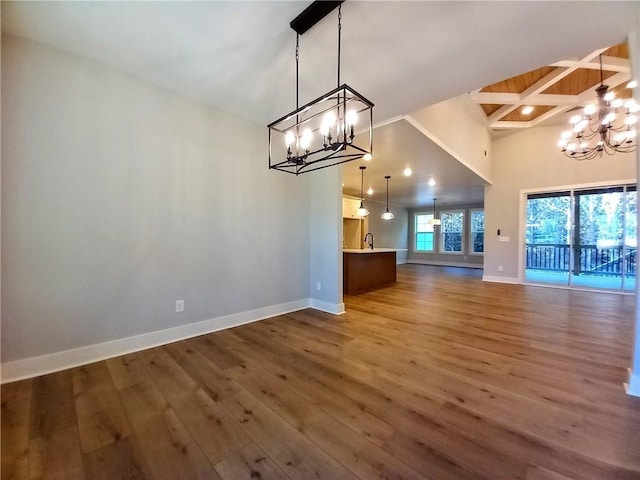 136 Rainey Rd, Temple, GA 30179 - unfurnished dining area with a chandelier, wood finished floors, beam ceiling, and a high ceiling