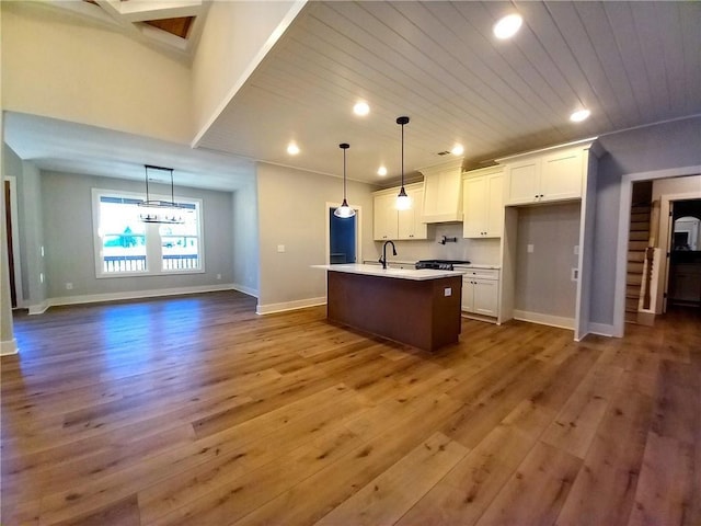 136 Rainey Rd, Temple, GA 30179 - kitchen featuring dark wood finished floors, white cabinetry, recessed lighting, a center island with sink, and light countertops