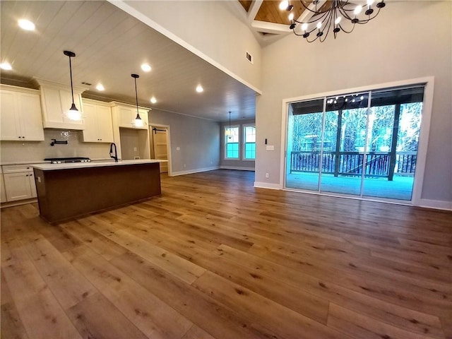 136 Rainey Rd, Temple, GA 30179 - kitchen featuring dark wood-style flooring, open floor plan, white cabinetry, stovetop, and light countertops