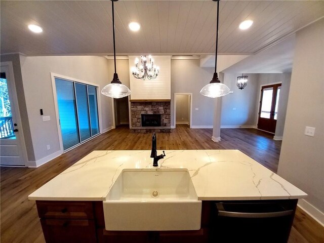 136 Rainey Rd, Temple, GA 30179 - kitchen featuring wood finished floors, wood ceiling, a chandelier, an island with sink, and light stone countertops