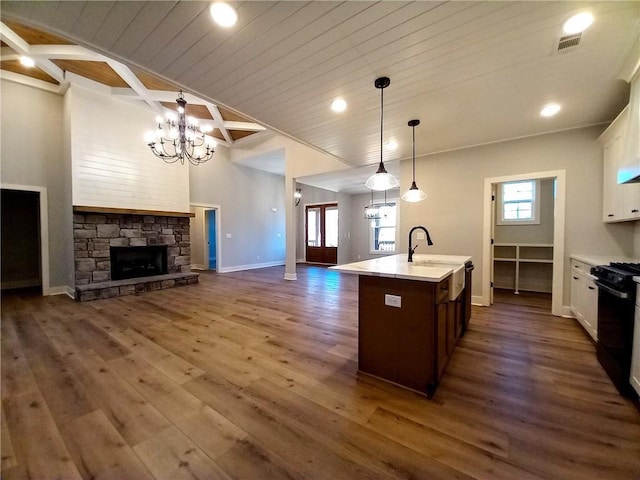 136 Rainey Rd, Temple, GA 30179 - kitchen with open floor plan, light countertops, a wooden ceiling with exposed beams, white cabinets, and dark wood-style floors