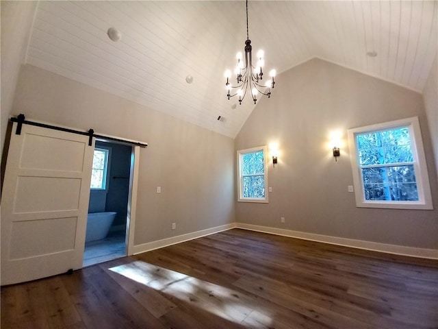 136 Rainey Rd, Temple, GA 30179 - unfurnished room featuring a chandelier, vaulted ceiling, dark wood-type flooring, and a barn door
