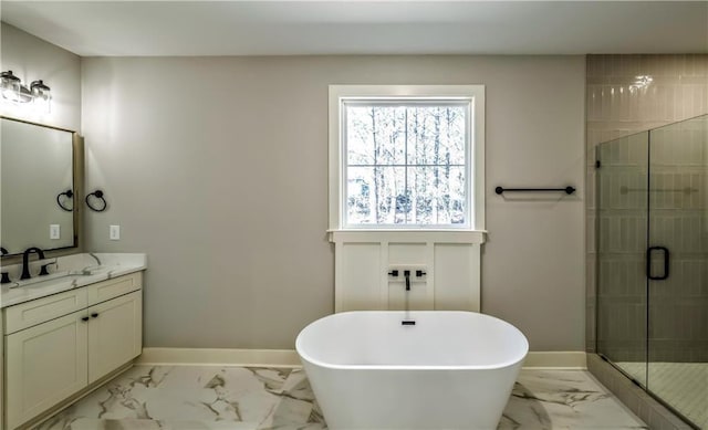 136 Rainey Rd, Temple, GA 30179 - bathroom featuring marble look tile flooring, vanity, a soaking tub, and a stall shower