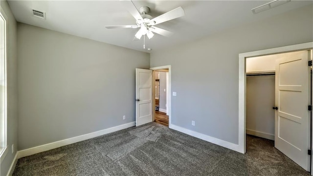 136 Rainey Rd, Temple, GA 30179 - unfurnished bedroom with dark colored carpet, a closet, a spacious closet, and ceiling fan