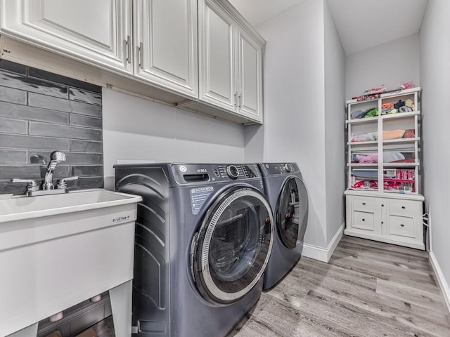 430 Cajun Dr, Ellijay, GA 30540 - washroom featuring cabinet space, light wood-type flooring, and washer and dryer