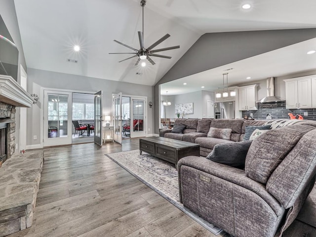 430 Cajun Dr, Ellijay, GA 30540 - living room featuring ceiling fan, a stone fireplace, light wood-type flooring, high vaulted ceiling, and recessed lighting
