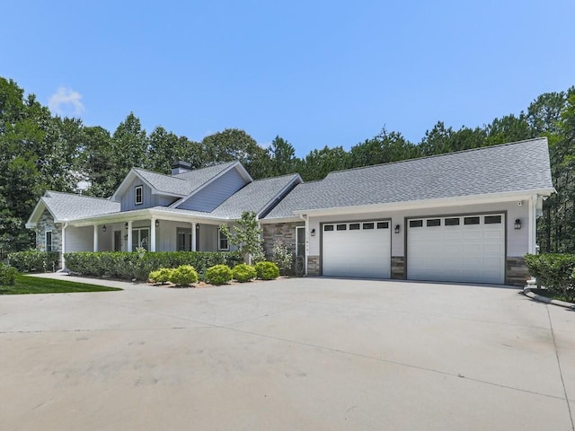 430 Cajun Dr, Ellijay, GA 30540 - view of front of house featuring driveway, a garage, stone siding, a chimney, and roof with shingles