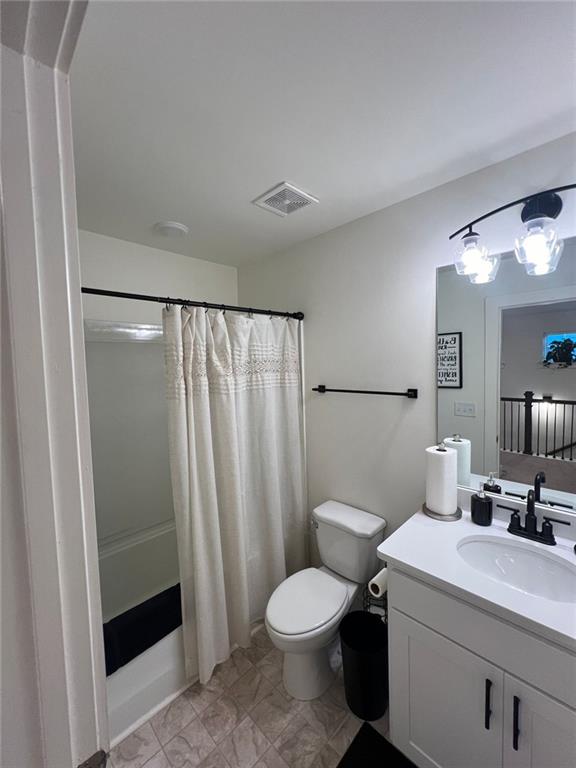 full bathroom with vanity, toilet, and shower / bathtub combination with curtain