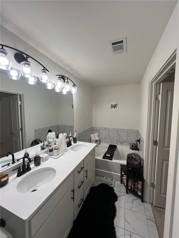 bathroom featuring a bath and vanity