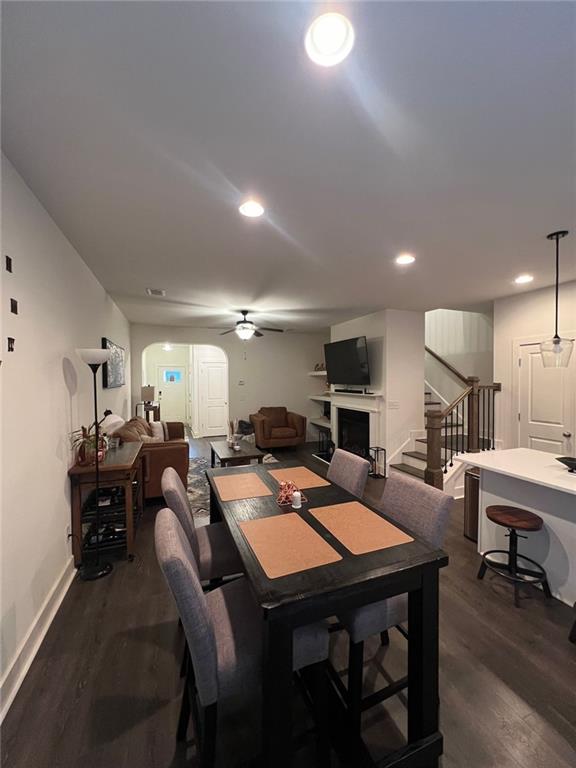 dining room with ceiling fan and dark hardwood / wood-style flooring