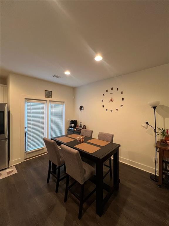 dining space with dark hardwood / wood-style flooring