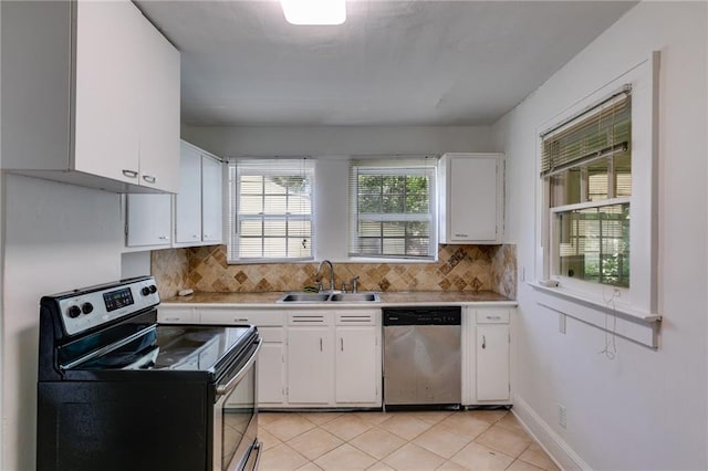 1834 Broad Ave, Atlanta, GA 30344 - kitchen with appliances with stainless steel finishes, a sink, light countertops, white cabinetry, and decorative backsplash