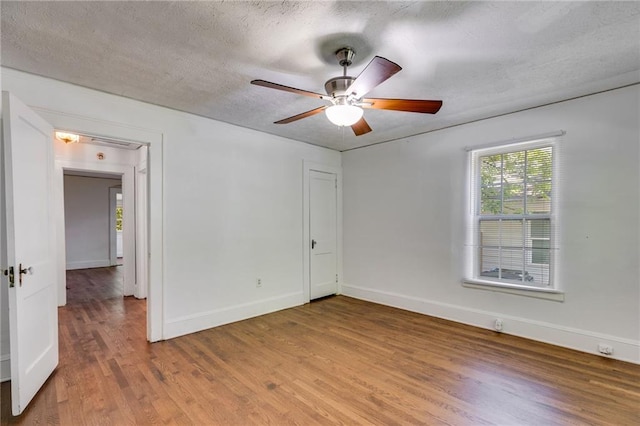 1834 Broad Ave, Atlanta, GA 30344 - empty room with wood finished floors, baseboards, a textured ceiling, and a ceiling fan