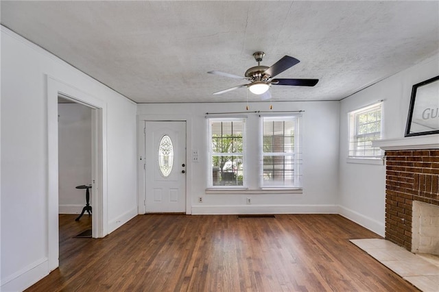 1834 Broad Ave, Atlanta, GA 30344 - foyer with wood finished floors, baseboards, a ceiling fan, a fireplace, and a textured ceiling
