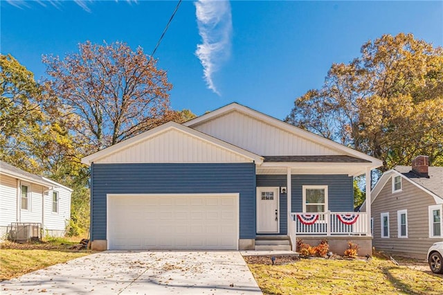 view of front of property featuring a porch, a garage, and a front lawn