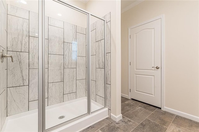 bathroom featuring ornamental molding and an enclosed shower