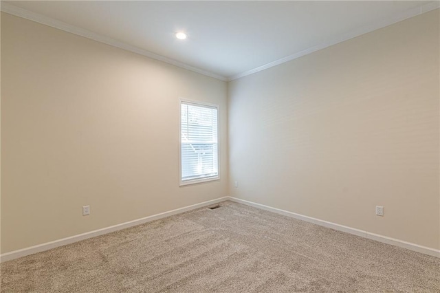 unfurnished room featuring carpet flooring and ornamental molding