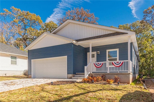 view of front facade featuring a porch, a garage, and a front lawn