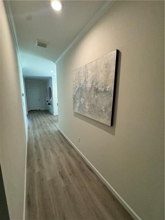 hall featuring crown molding and hardwood / wood-style flooring